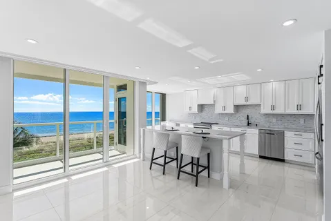 a kitchen with a sink and chairs