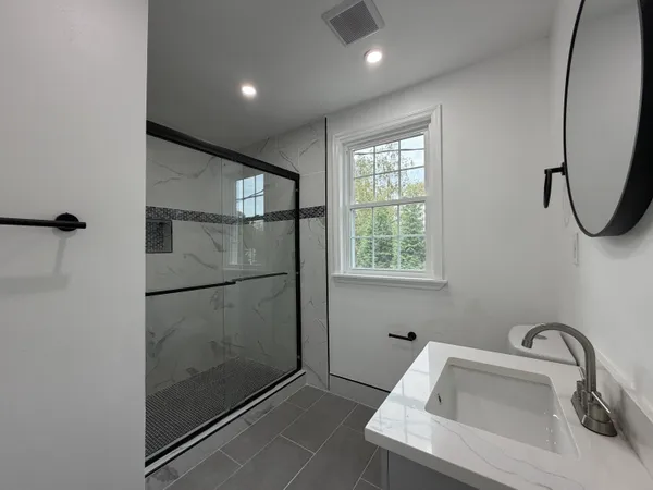 a bathroom with a sink and shower