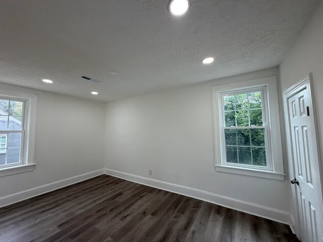 a view of wooden floor and windows in a room