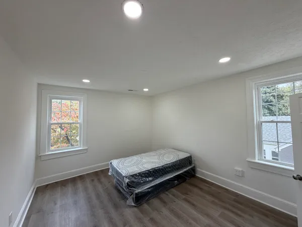 a room with a window and wooden floor