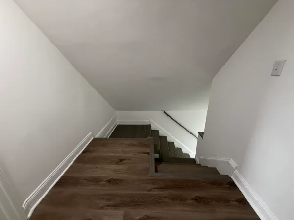 a view of entryway and hall with wooden floor