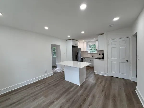 a view of kitchen with wooden floor and electronic appliances