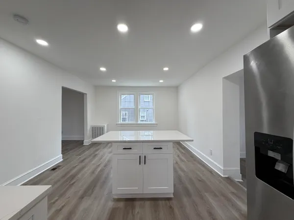 an empty room with wooden floor and fireplace