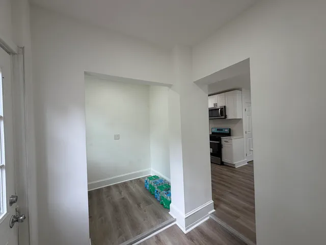 a view of walk in closet with wooden floor
