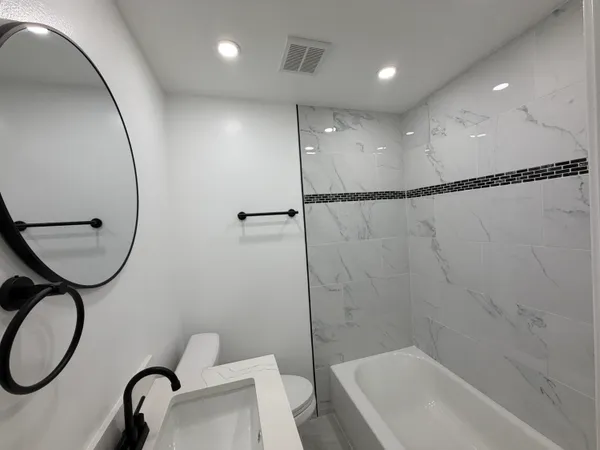 a bathroom with a toilet a sink and a mirror