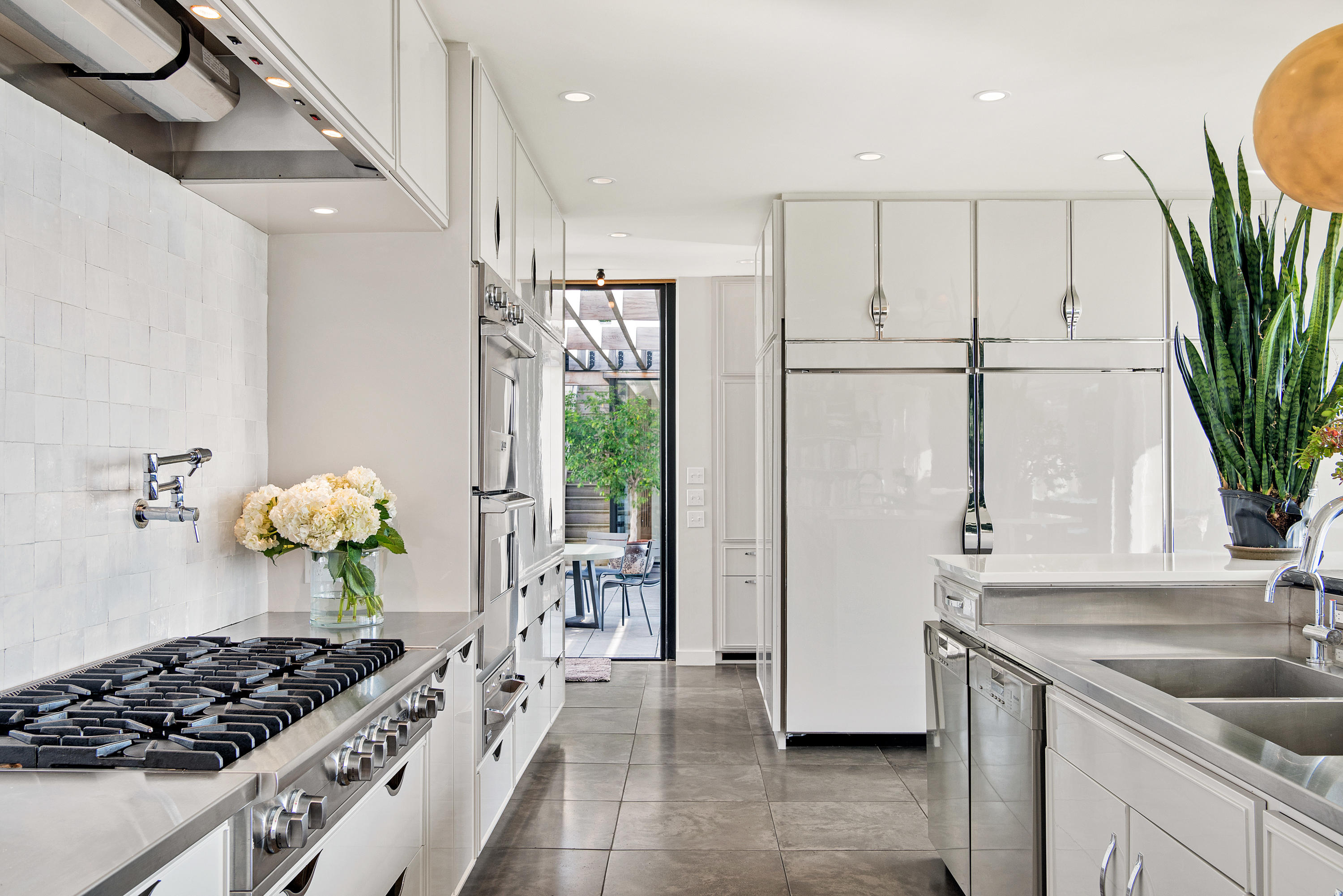 163 Pear Tree Point Road Darien, CT 06820 - Photo 15 of 24 a kitchen with stainless steel appliances granite countertop a refrigerator a sink a stove and white cabinets