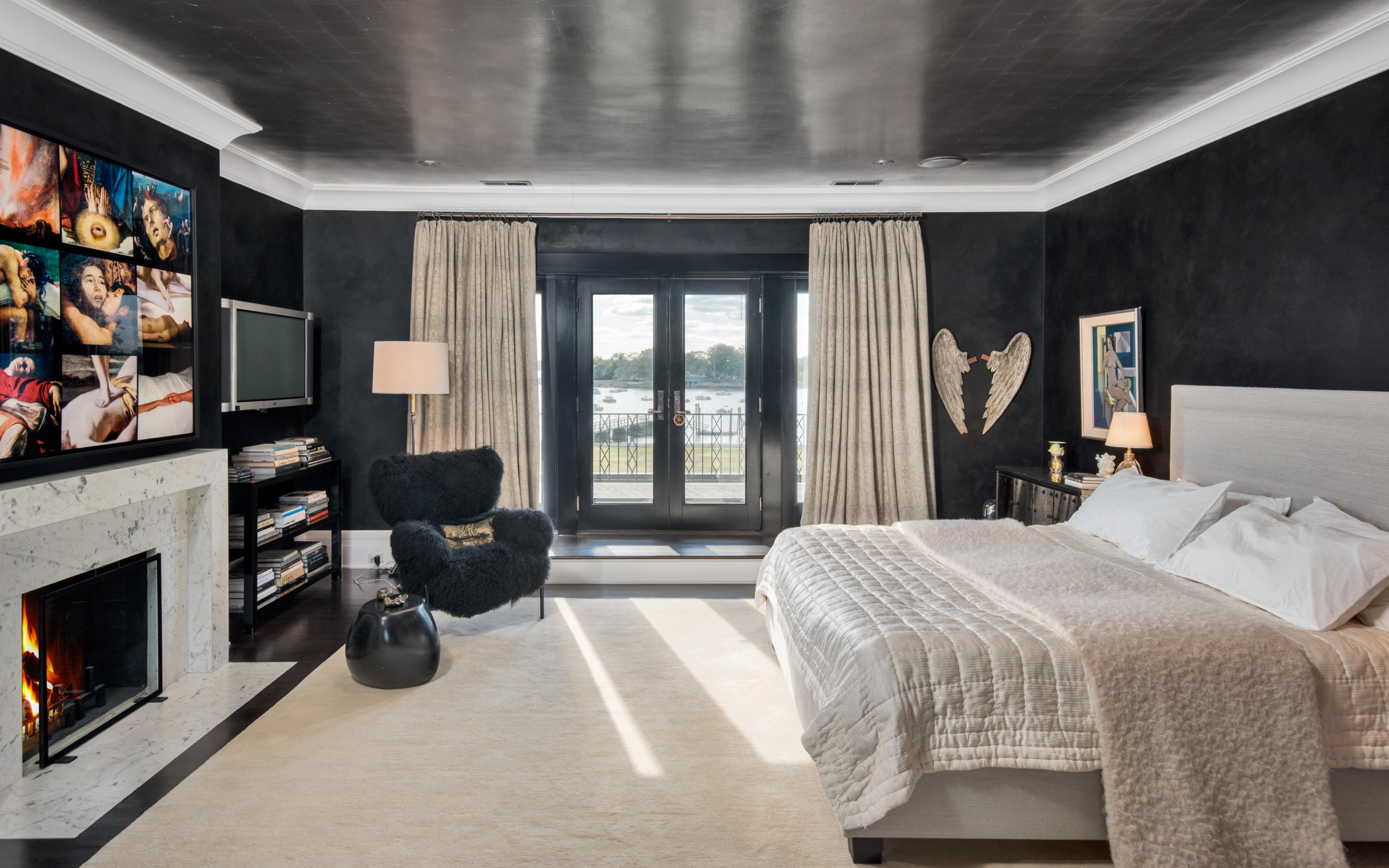 163 Pear Tree Point Road Darien, CT 06820 - Photo 19 of 24 a bedroom with a bed flat screen tv and a large window