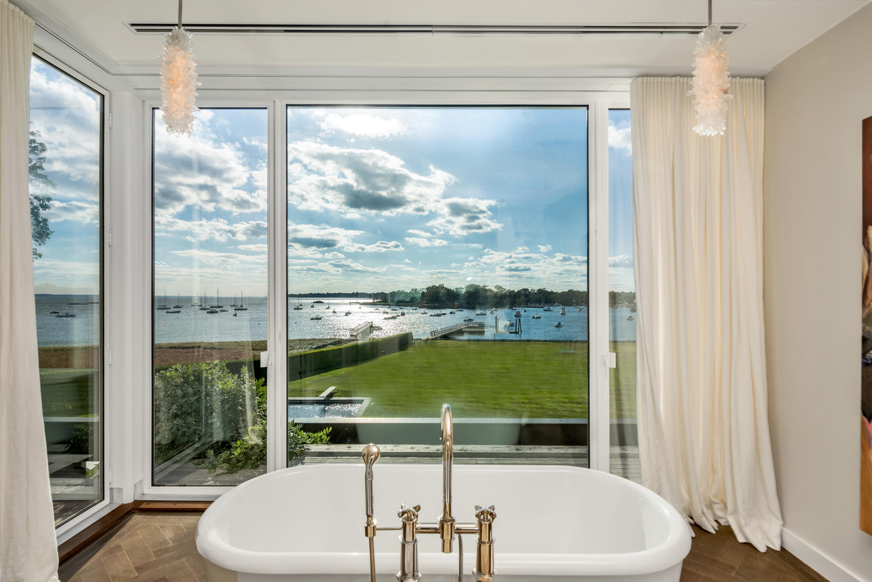 163 Pear Tree Point Road Darien, CT 06820 - Photo 22 of 24 a room with a large window and a table