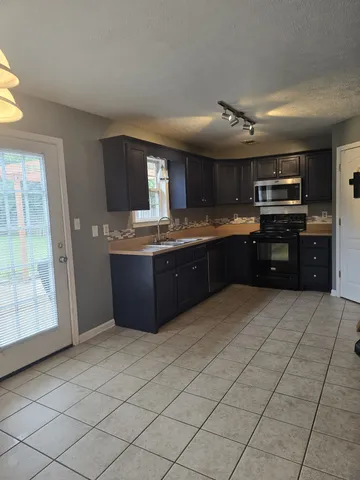 a kitchen with a refrigerator and a sink