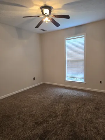 a bathroom with a toilet and a shower curtain