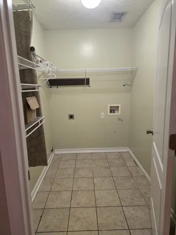 a view of a backyard with table and chairs under an umbrella