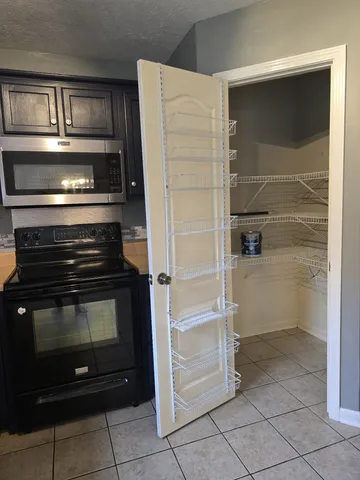 a kitchen with granite countertop a refrigerator and a sink