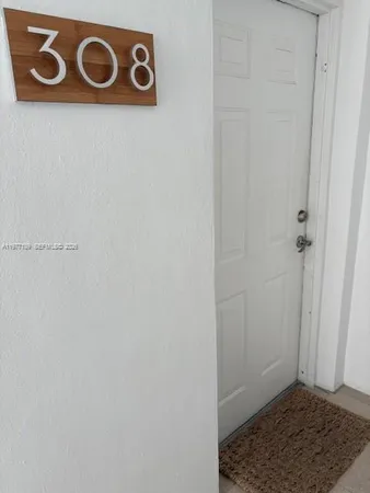 a living room with furniture and a lamp