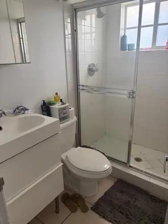 a bedroom with a bed and ceiling fan