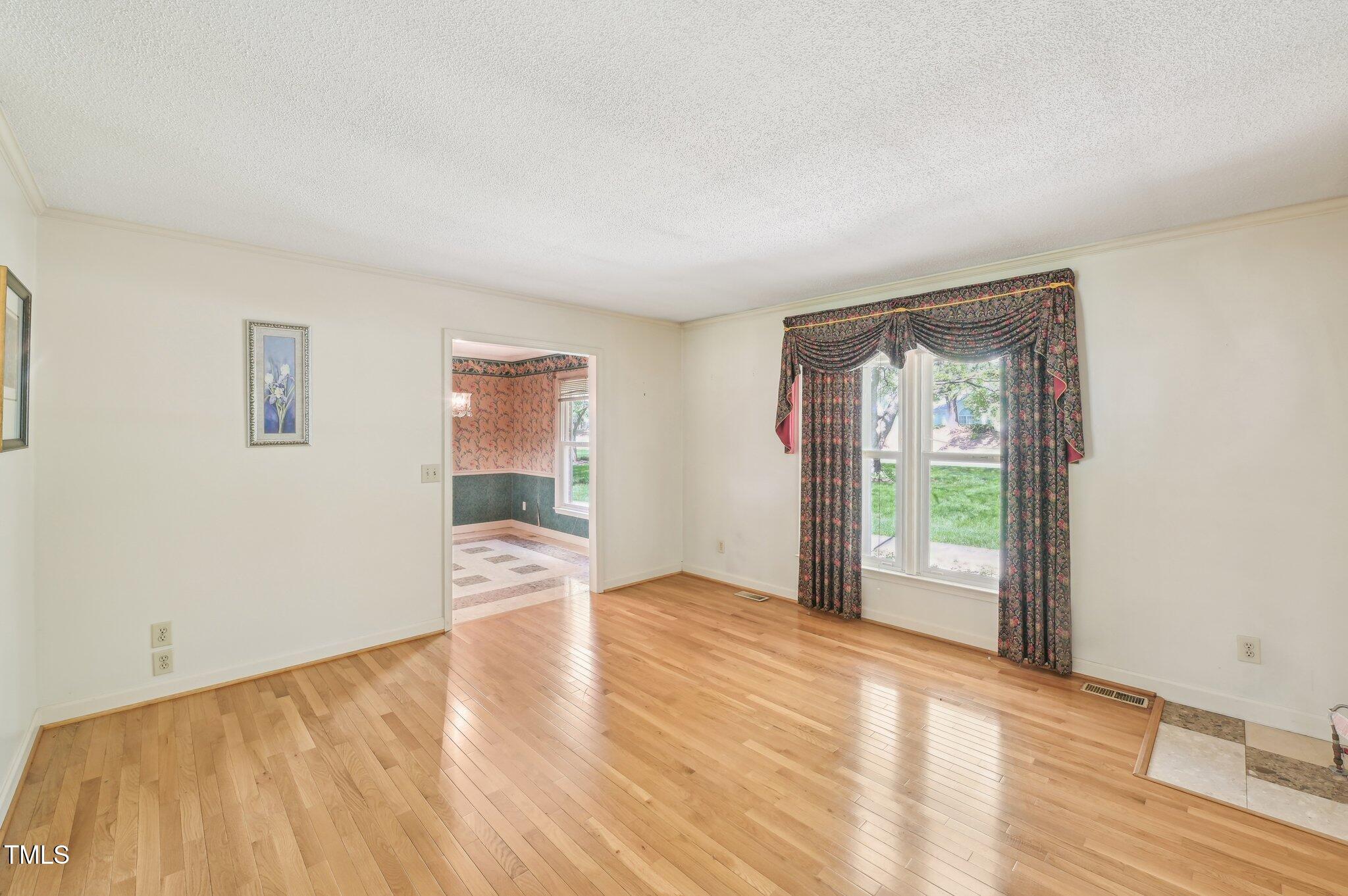 3011 Old Hillsborough Road Mebane, NC 27302 - Photo 12 of 29 wooden floor in an empty room with a window