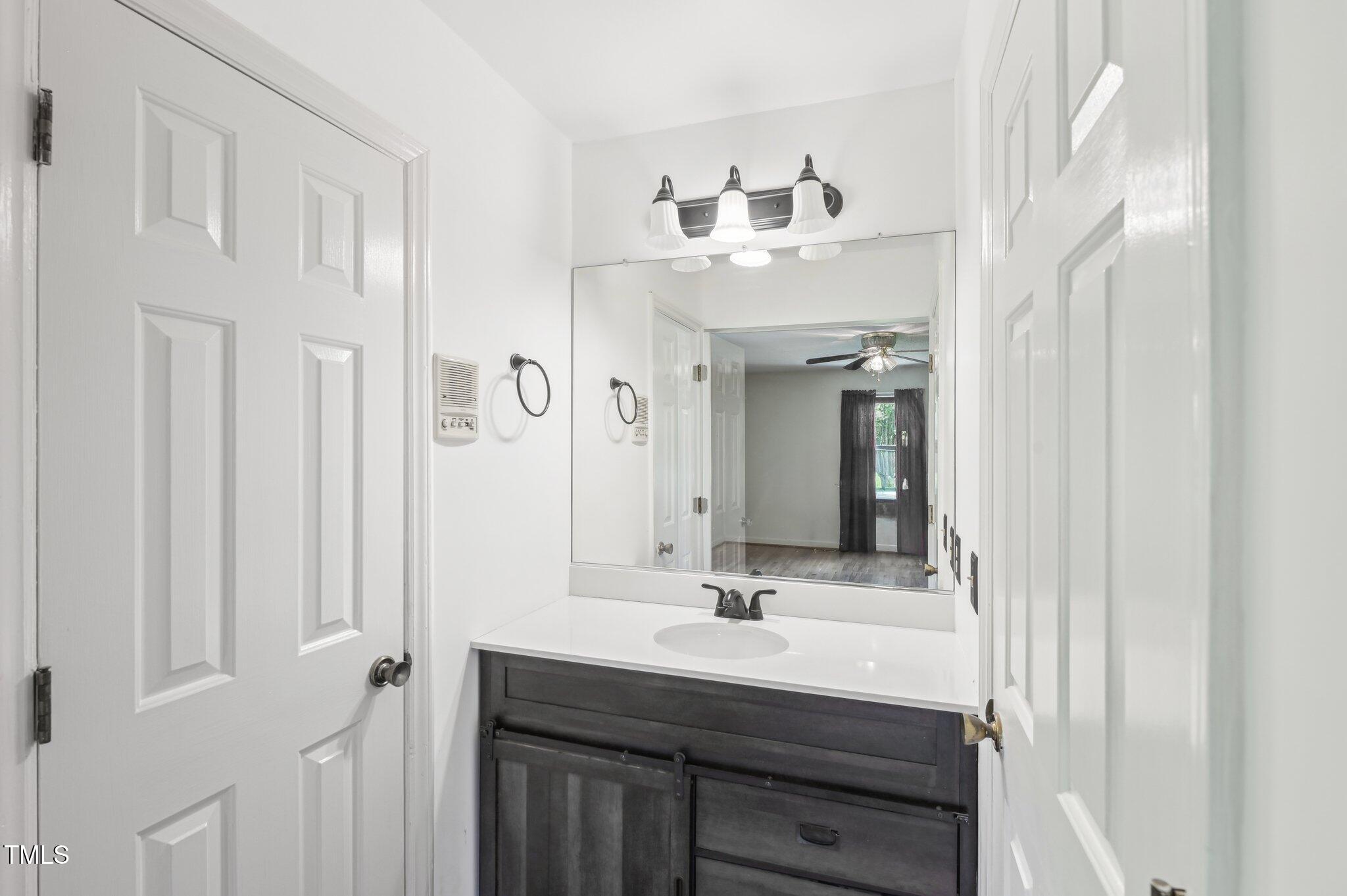 3011 Old Hillsborough Road Mebane, NC 27302 - Photo 18 of 29 a bathroom with double vanity sink and a mirror
