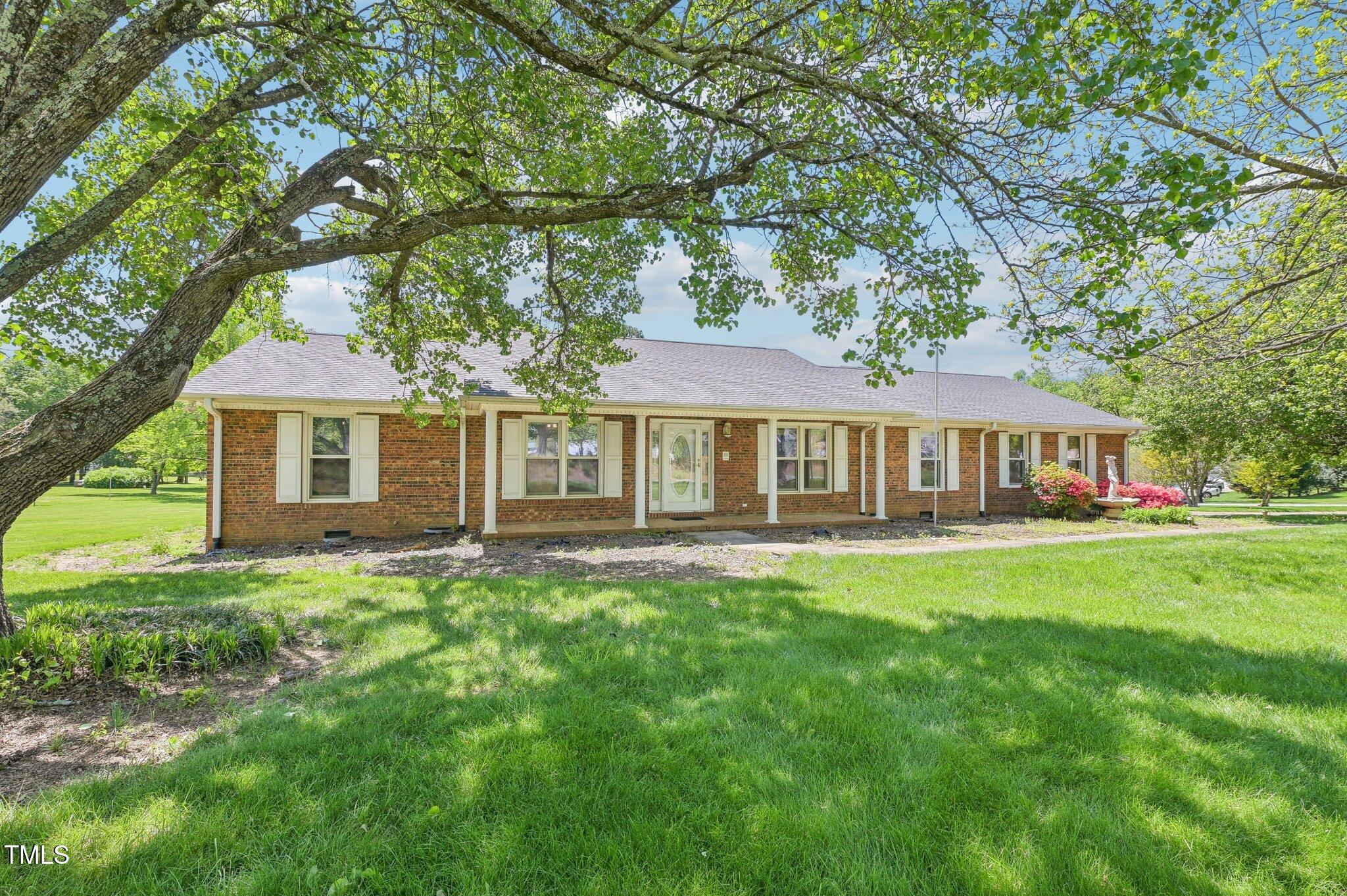 3011 Old Hillsborough Road Mebane, NC 27302 - Photo 2 of 29 a front view of a house with a garden
