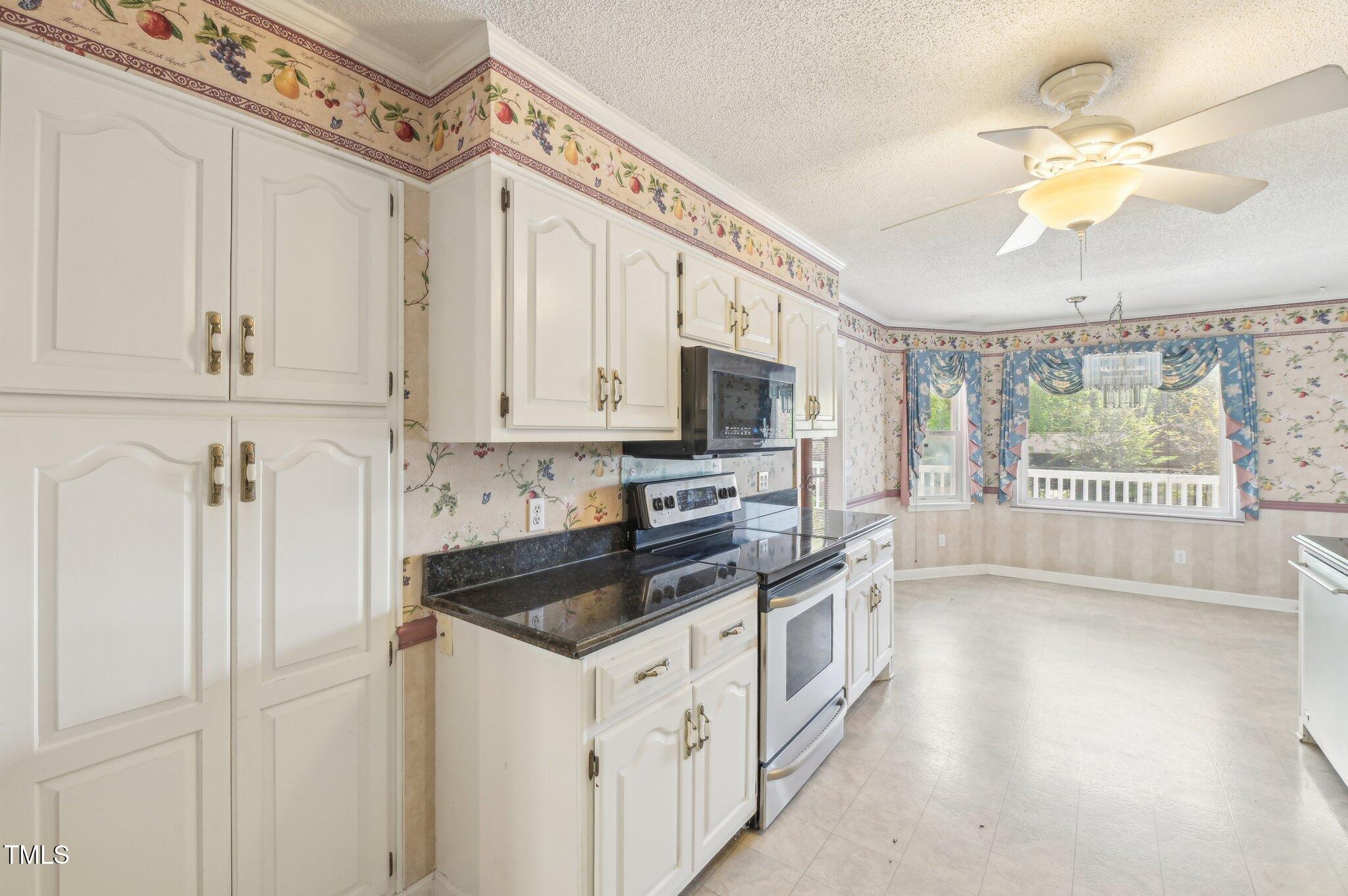 3011 Old Hillsborough Road Mebane, NC 27302 - Photo 8 of 29 a kitchen with stainless steel appliances granite countertop a stove a sink and a refrigerator