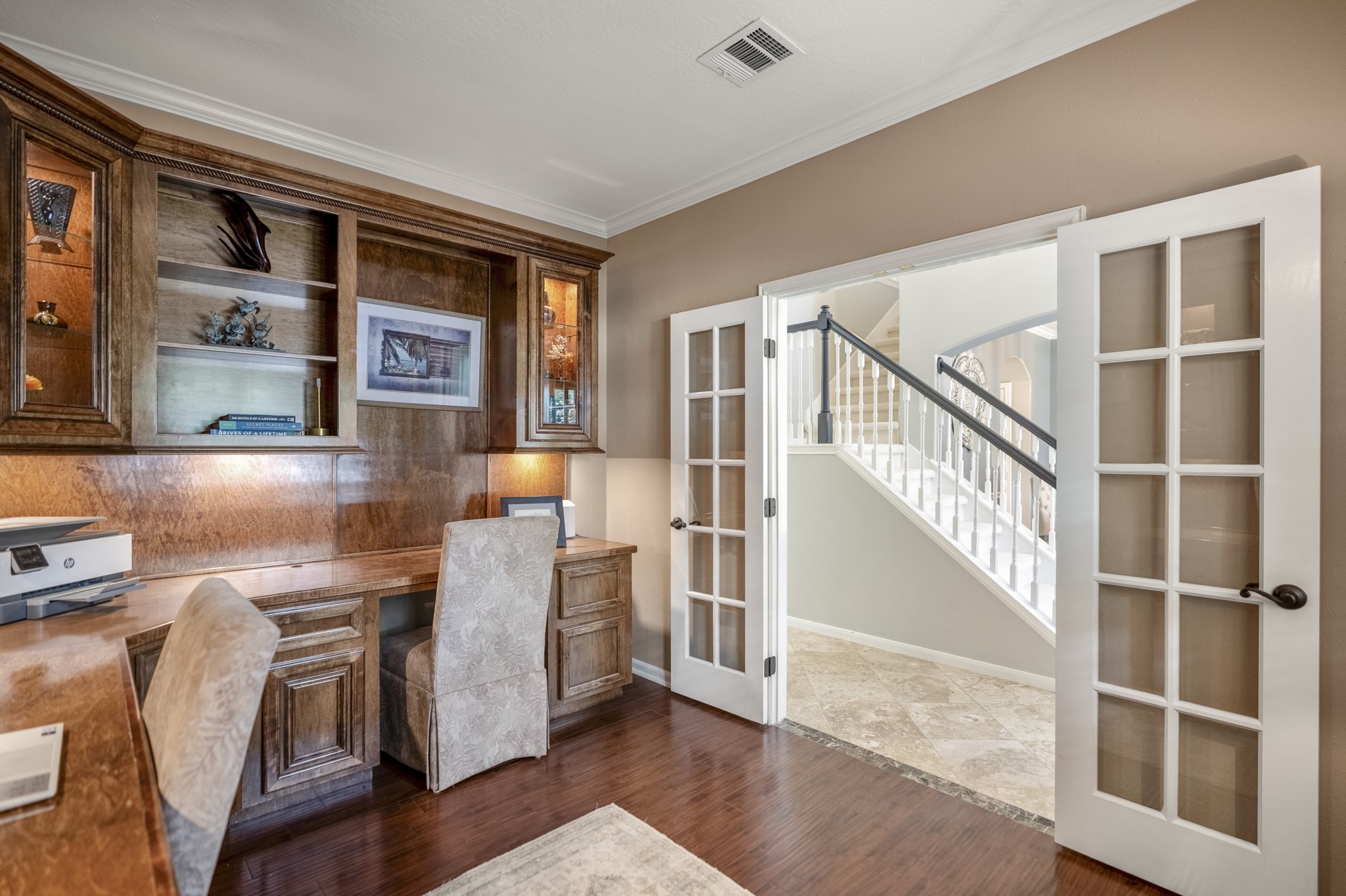 20235 Eden Pines Spring, TX 77379 - Photo 6 of 50 Another angle of the office shows how well it connects back to the rest of the home. French doors open directly to the foyer, keeping the workspace easy to access while still giving you the option to close it off, and the built-in maple cabinetry continues across the room for a cohesive, functional setup.
