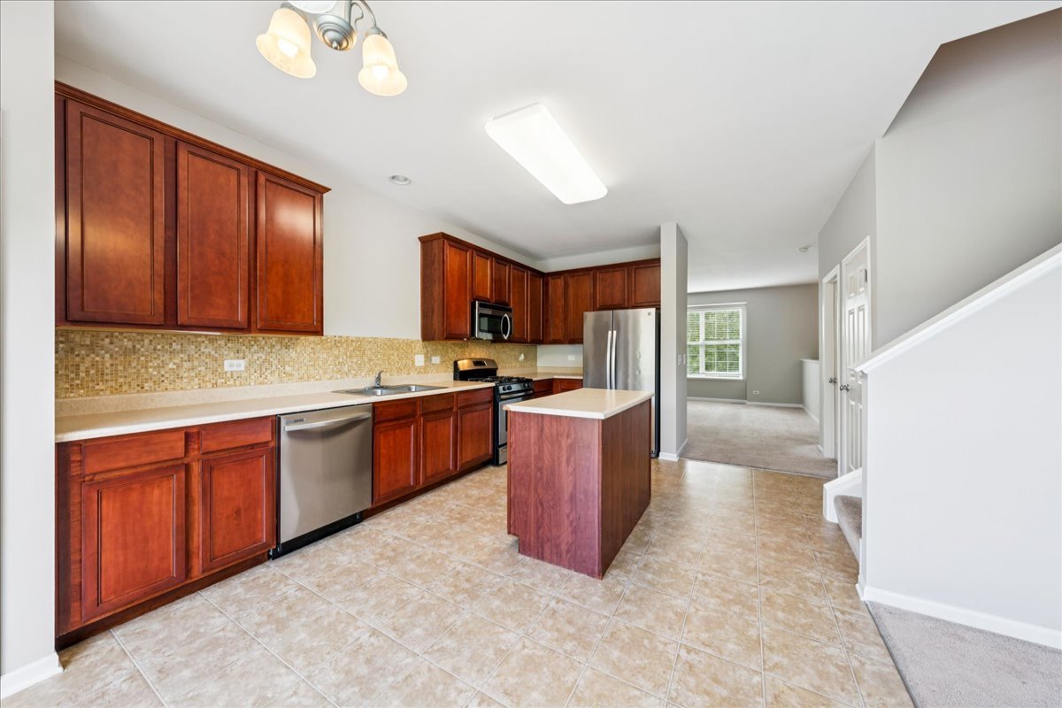 233 Jackson Street Gilberts, IL 60136 - Photo 11 of 29 a kitchen with sink cabinets and window