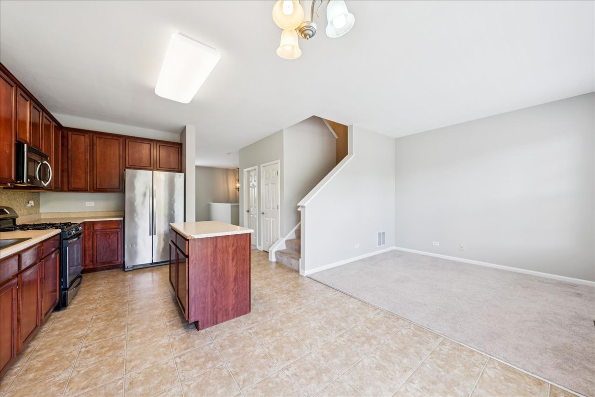 233 Jackson Street Gilberts, IL 60136 - Photo 12 of 29 a kitchen with cabinets and wooden floor