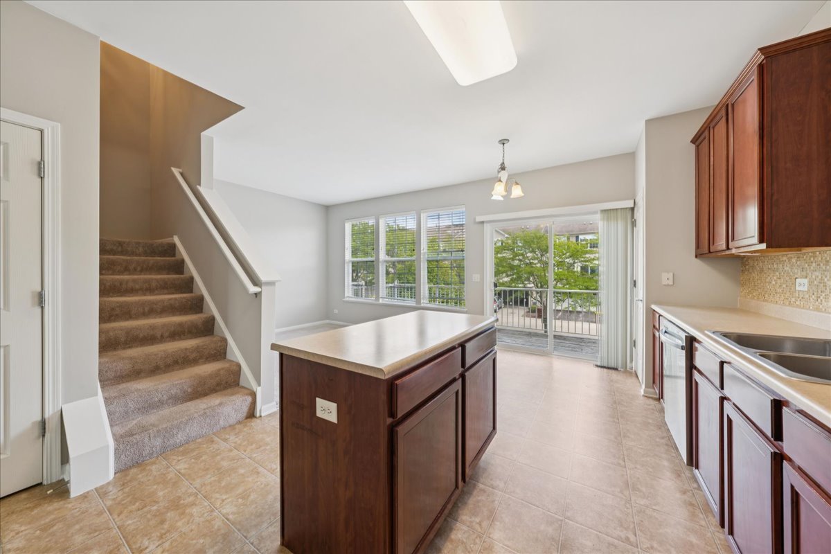 233 Jackson Street Gilberts, IL 60136 - Photo 6 of 29 a kitchen with sink cabinets and wooden floor
