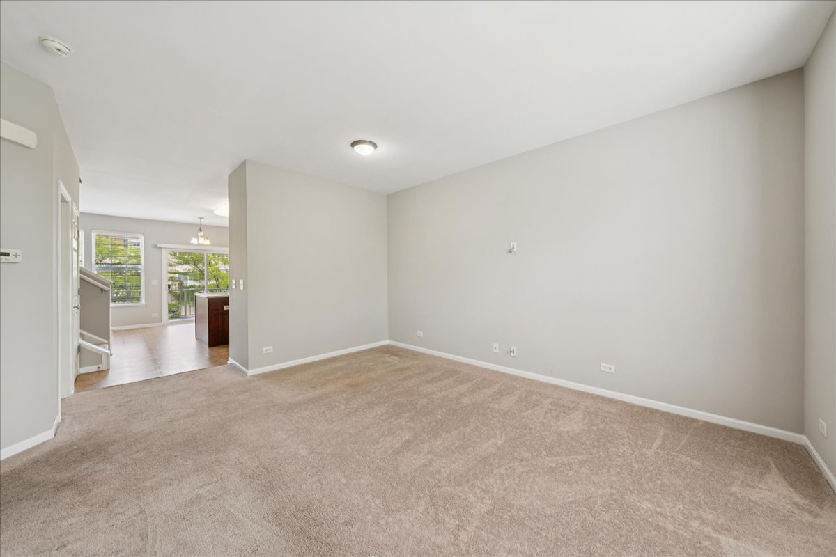 233 Jackson Street Gilberts, IL 60136 - Photo 9 of 29 a view of a big room with wooden floor and windows