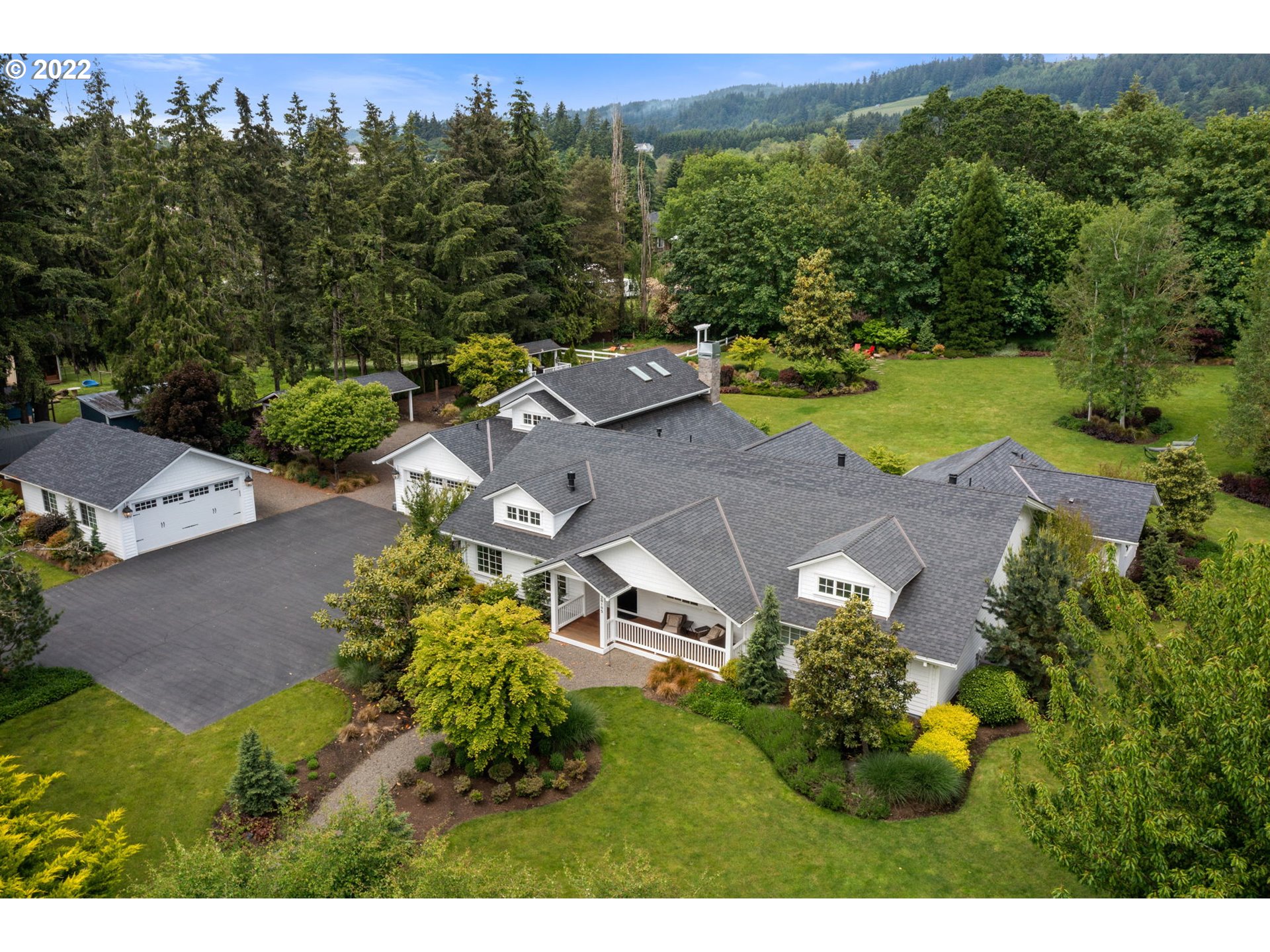 an aerial view of a house with a yard swimming pool and outdoor seating