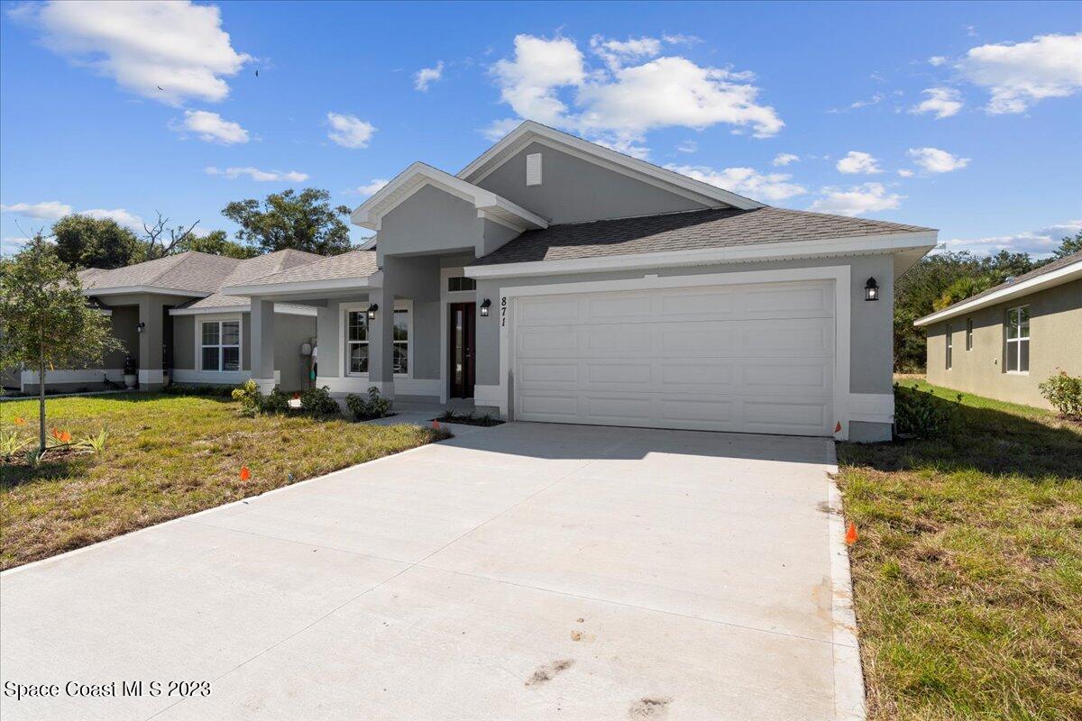 1341 Tupelo Circle Cocoa, FL 32926 - Photo 2 of 27 a front view of a house with a yard and garage
