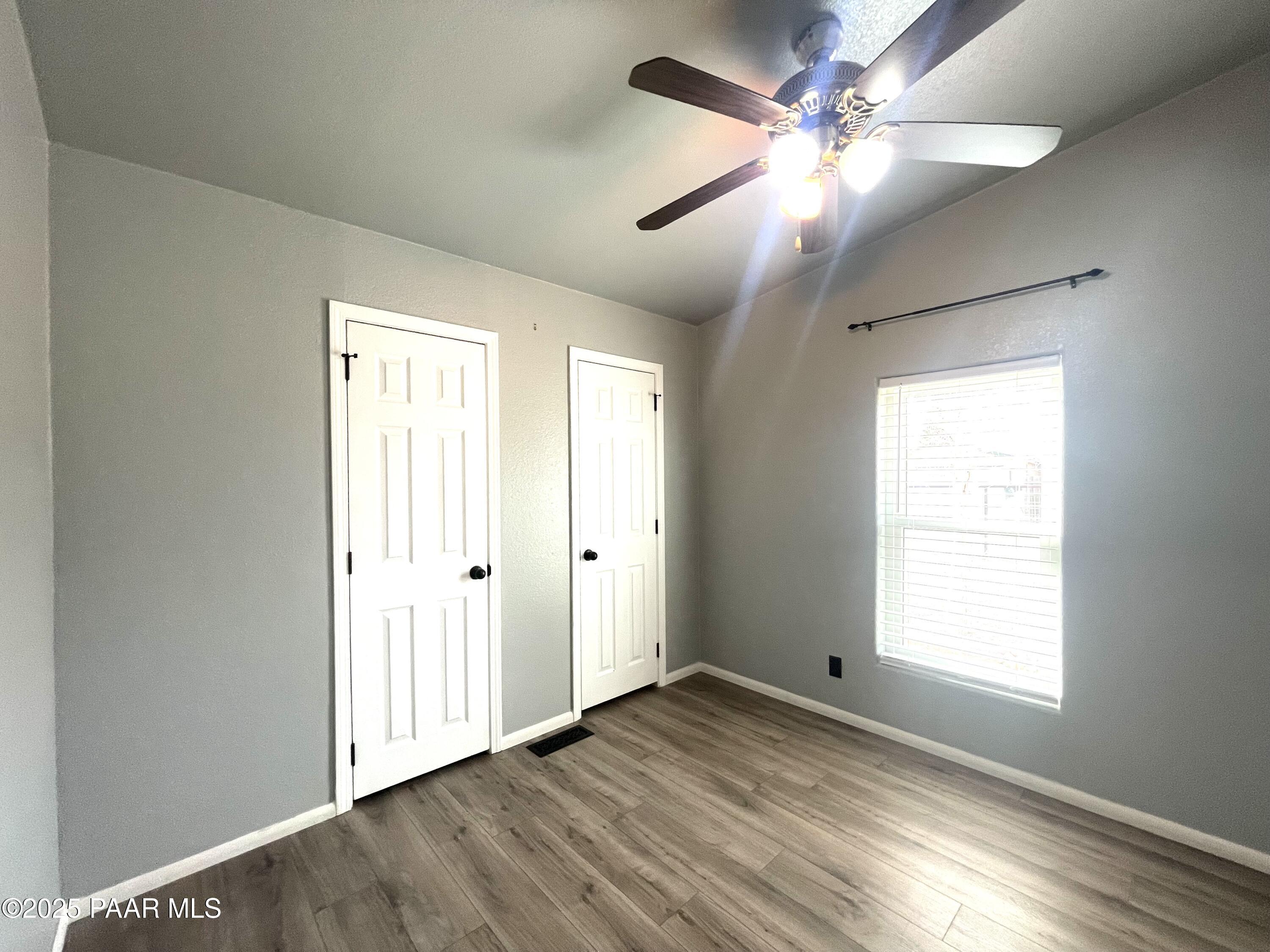 22355 North Docs Road Paulden, AZ 86334 - Photo 12 of 20 a view of empty room with wooden floor and fan