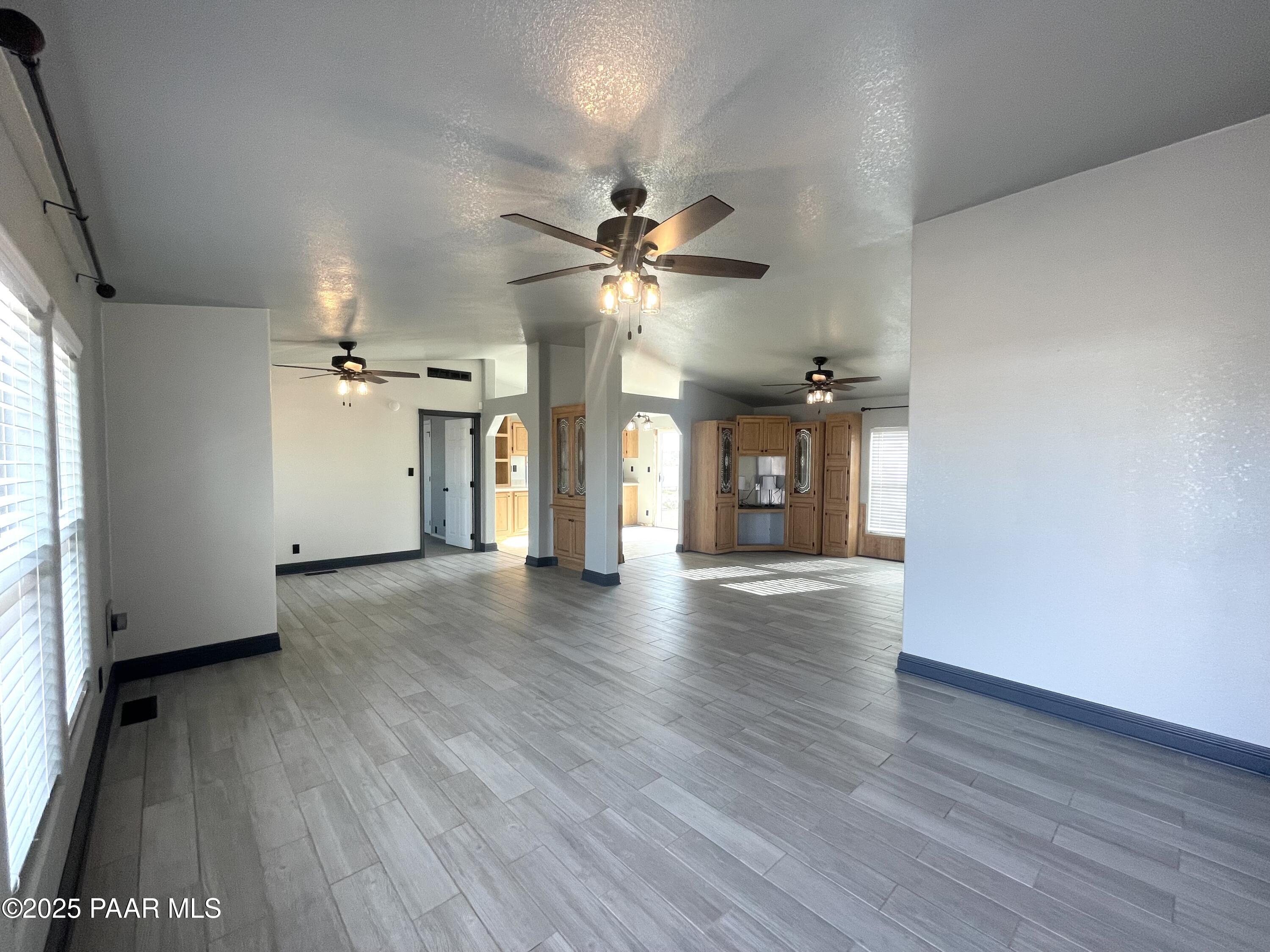 22355 North Docs Road Paulden, AZ 86334 - Photo 3 of 20 a view of an empty room with window and wooden floor
