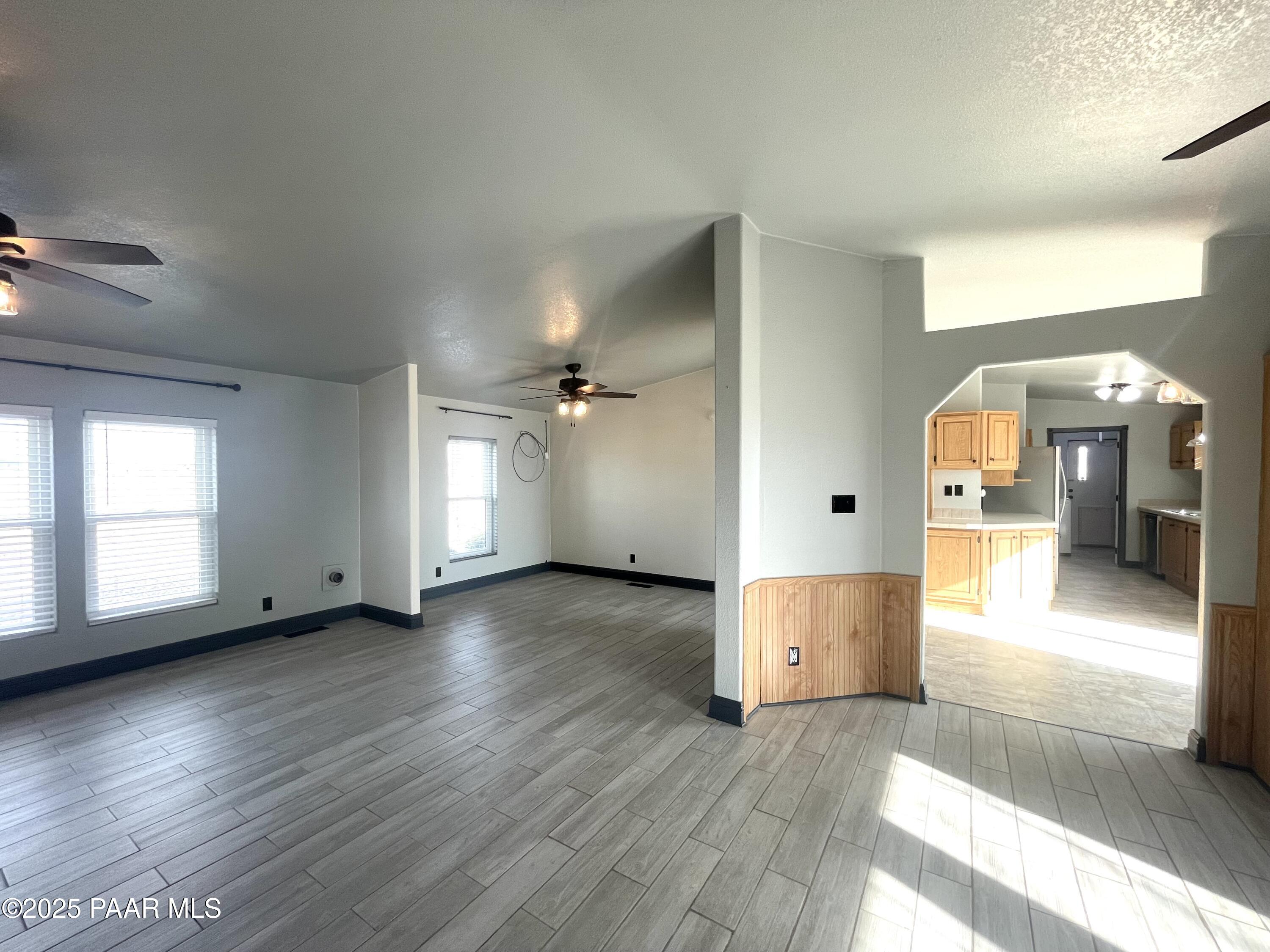 22355 North Docs Road Paulden, AZ 86334 - Photo 4 of 20 an empty room with wooden floor and windows