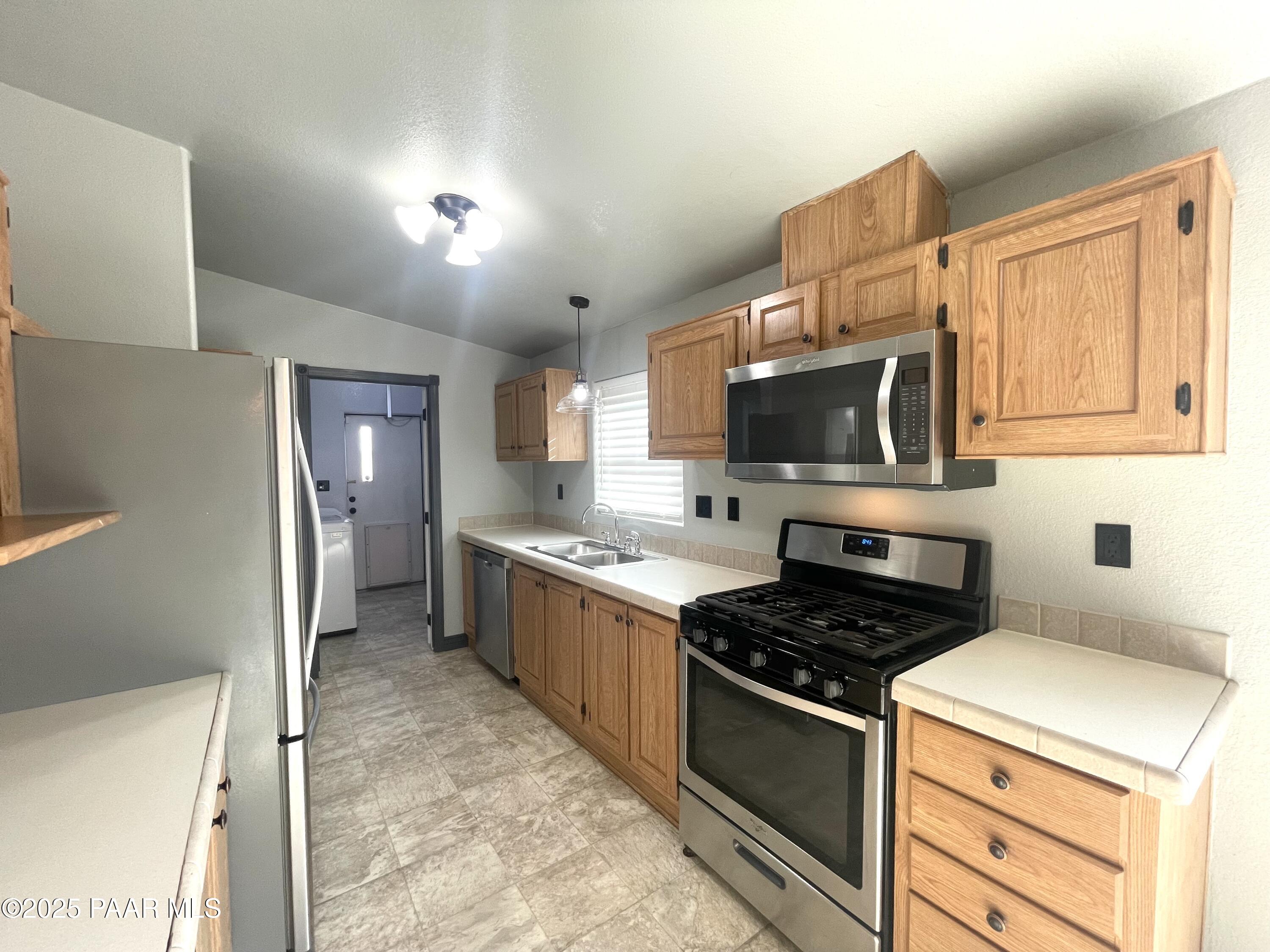 22355 North Docs Road Paulden, AZ 86334 - Photo 6 of 20 a kitchen with stainless steel appliances a stove a microwave and a refrigerator