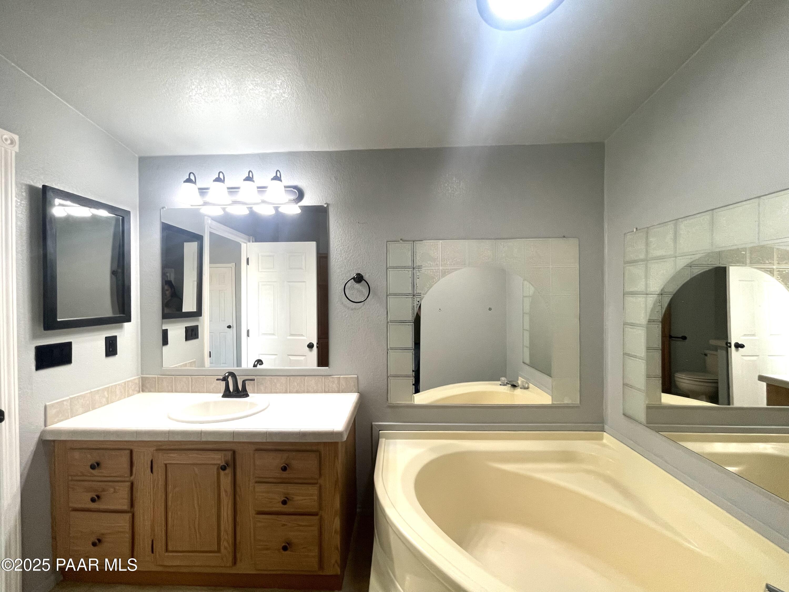 22355 North Docs Road Paulden, AZ 86334 - Photo 9 of 20 a bathroom with a tub sink and mirror