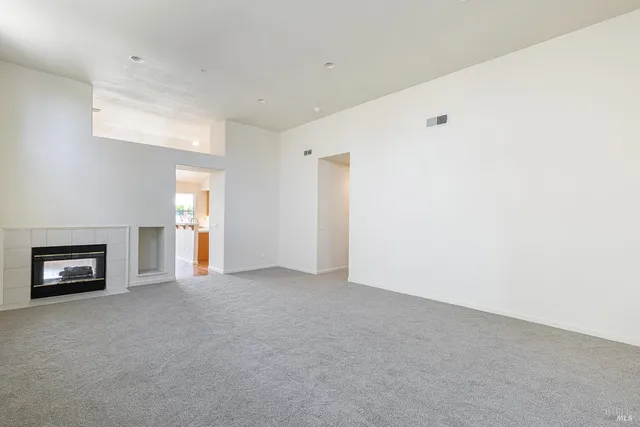 a large kitchen with cabinets wooden floor and stainless steel appliances