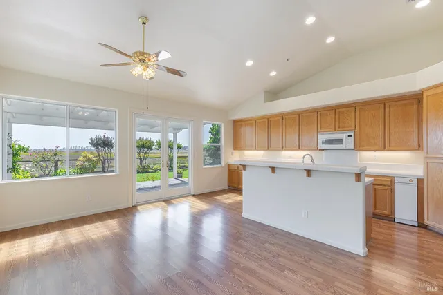 a kitchen with a sink cabinets and wooden floor