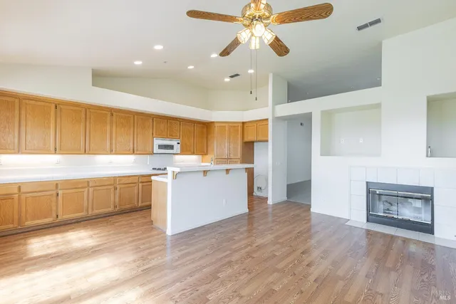 a bathroom with a granite countertop sink a large mirror and a large window