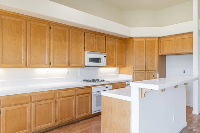 a view of room with window ceiling fan and wooden floor