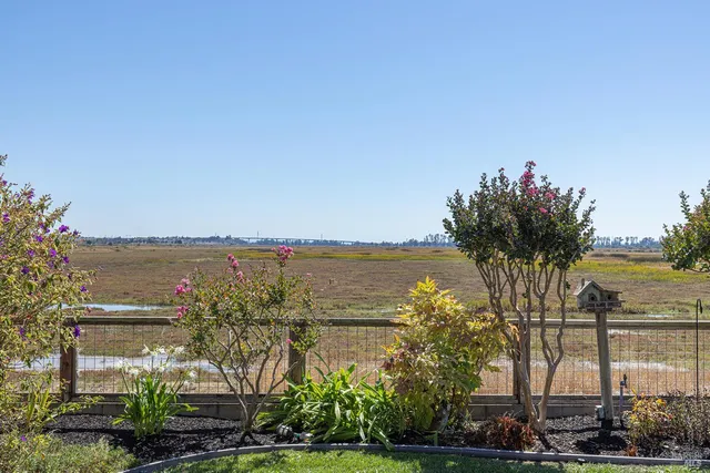 a view of a patio with a table and chairs under an umbrella