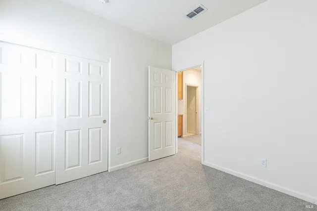 an aerial view of ocean and residential houses with outdoor space