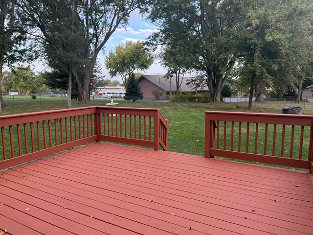 a deck with trees in front of it