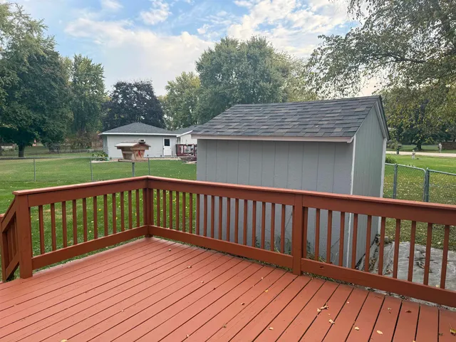 a balcony with wooden floor and fence
