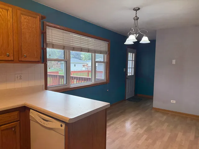 a view of a kitchen with a sink and cabinet
