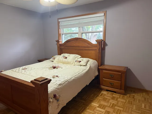 a bed sitting in a bedroom next to a window