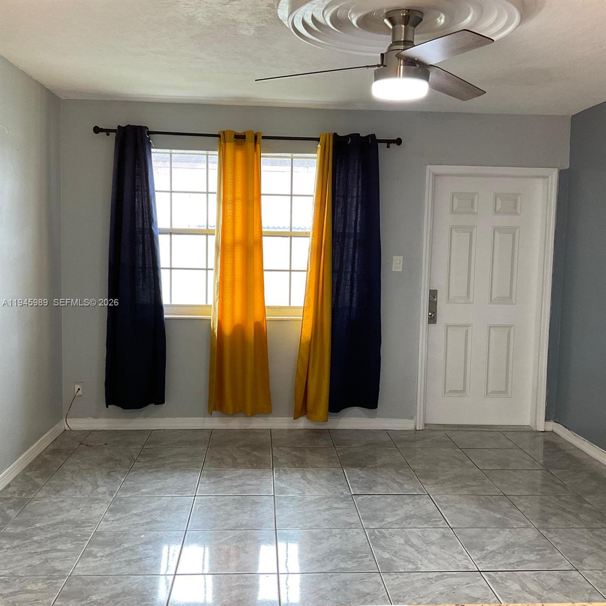 337 Phippen Waiters Road, Unit 12 Dania Beach, FL 33004 - Photo 4 of 9 a view of an empty room with a window