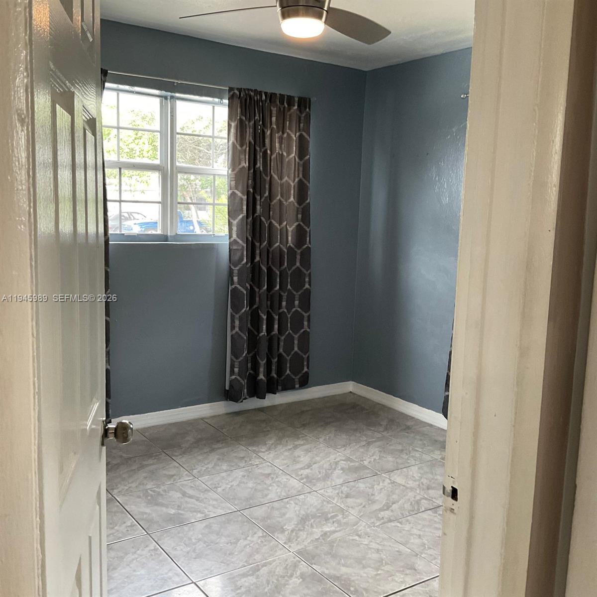 337 Phippen Waiters Road, Unit 12 Dania Beach, FL 33004 - Photo 5 of 9 a view of an empty room with a window