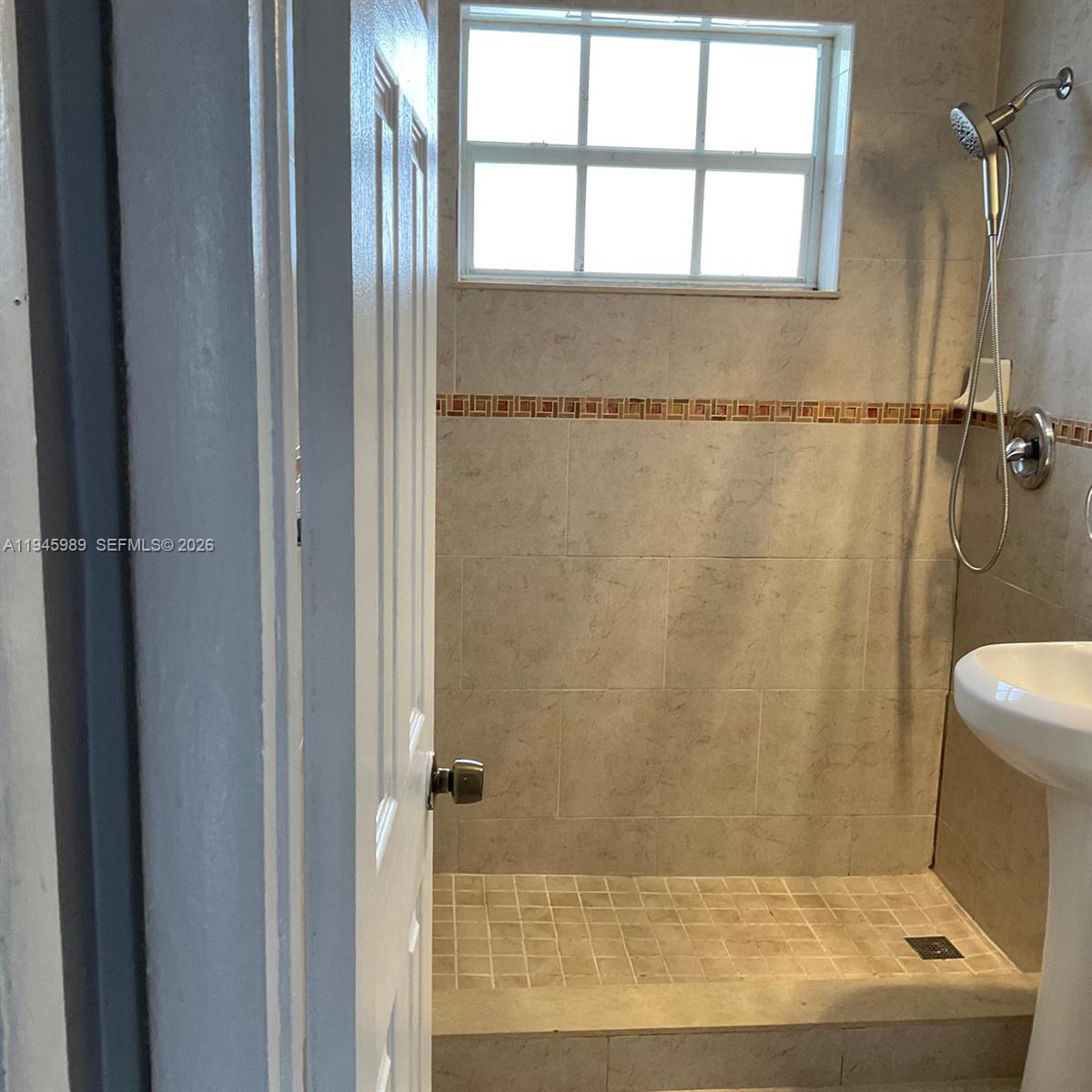 337 Phippen Waiters Road, Unit 12 Dania Beach, FL 33004 - Photo 9 of 9 a bathroom with a shower