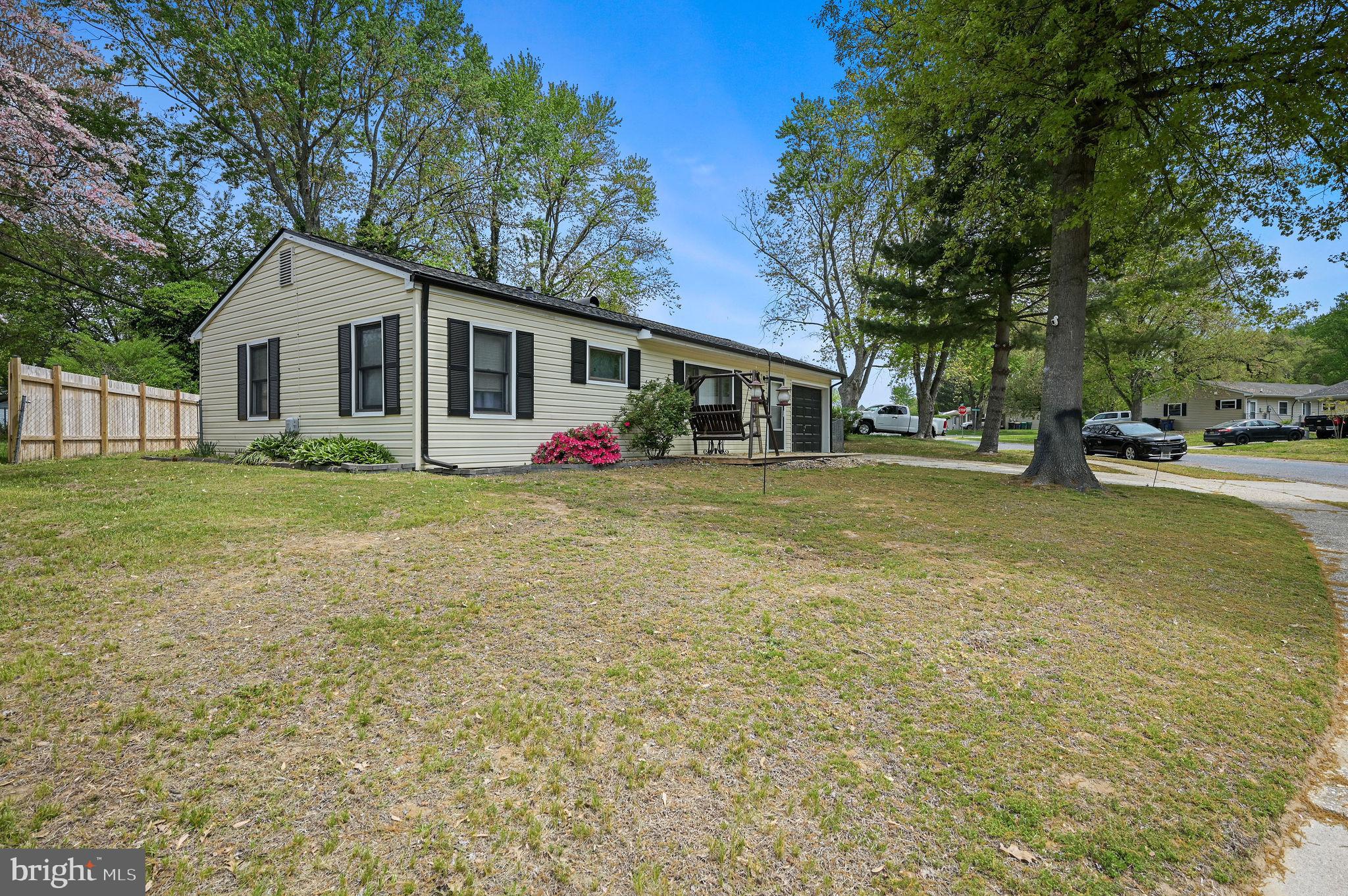 a view of a house with a yard and sitting area