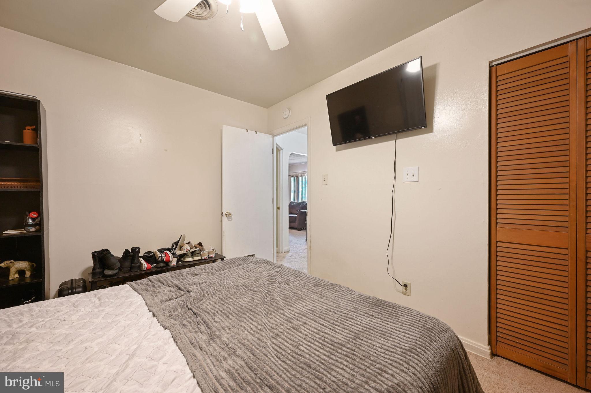 87 Wayne Drive Dover, DE 19901 - Photo 13 of 20 a bedroom with a bed and a flat screen tv