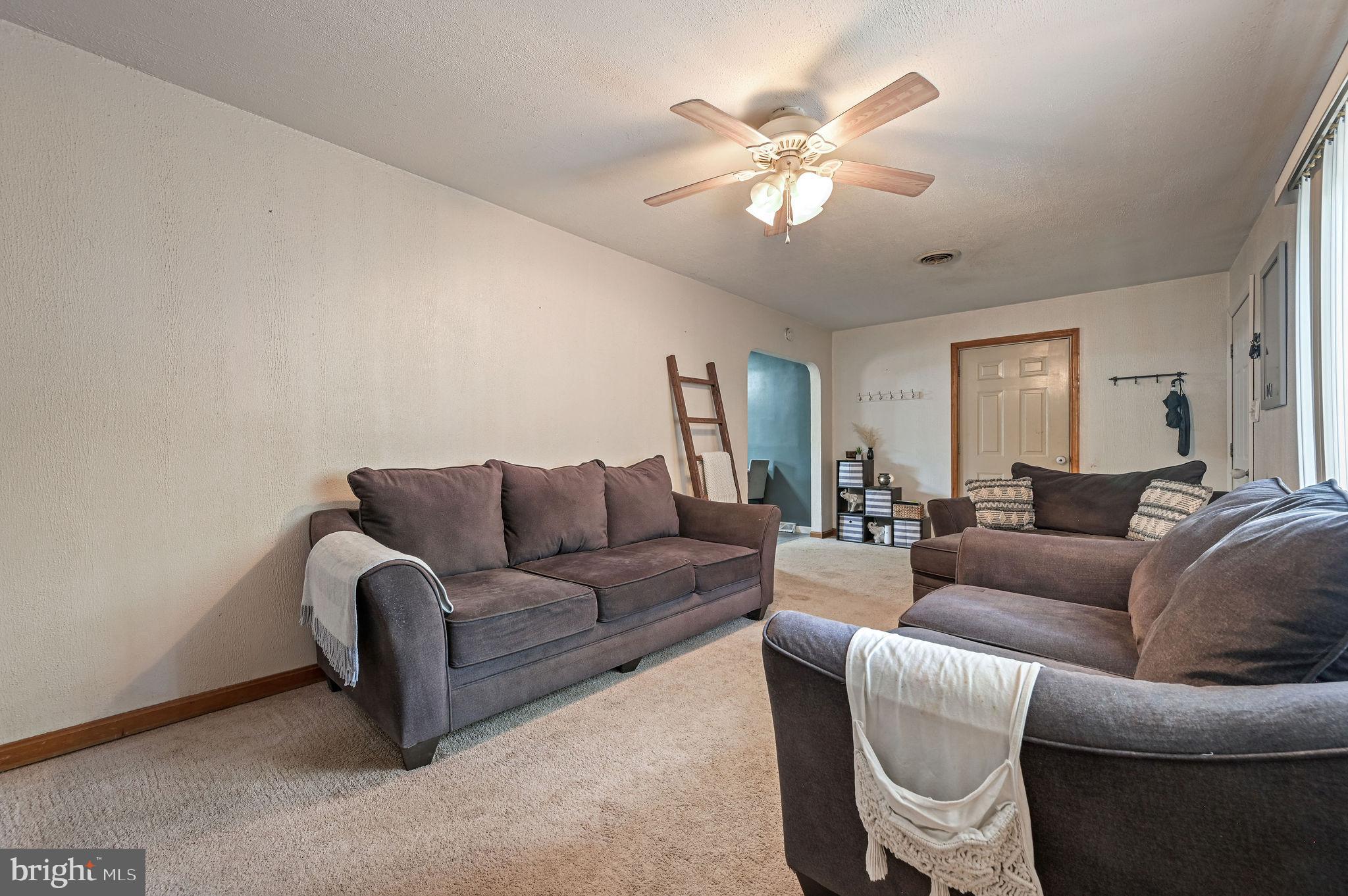 87 Wayne Drive Dover, DE 19901 - Photo 9 of 20 a living room with furniture a chandelier and a couch
